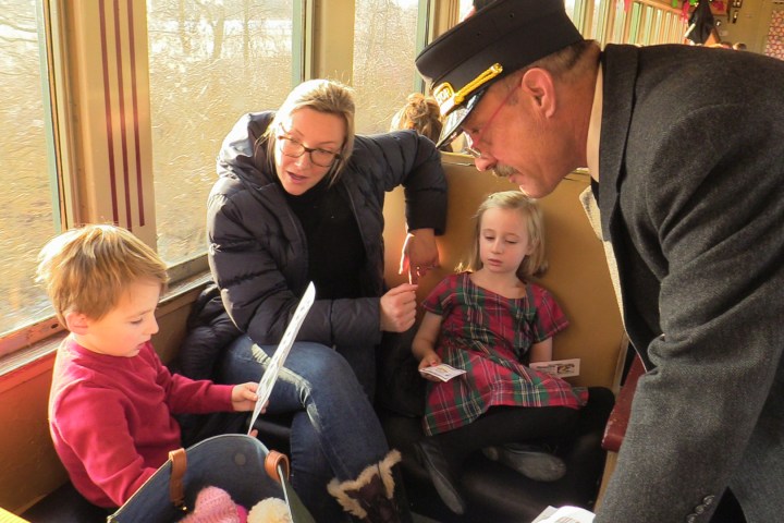 a group of people sitting next to a child