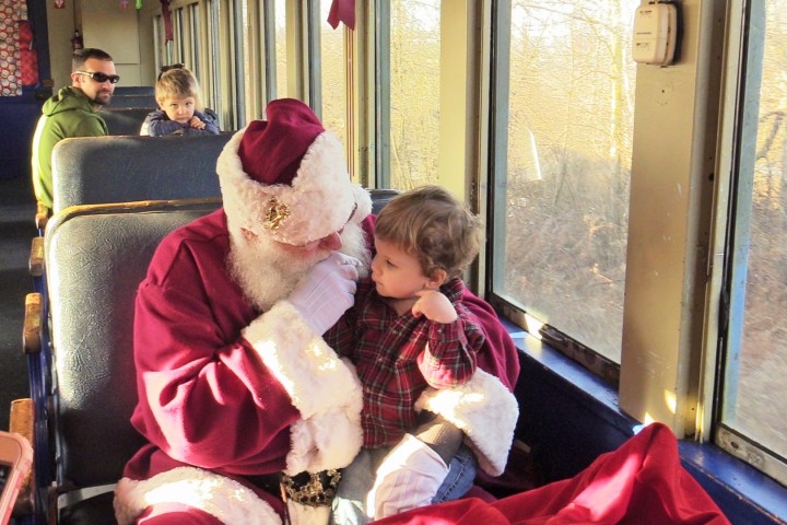 a group of young children sitting next to a window