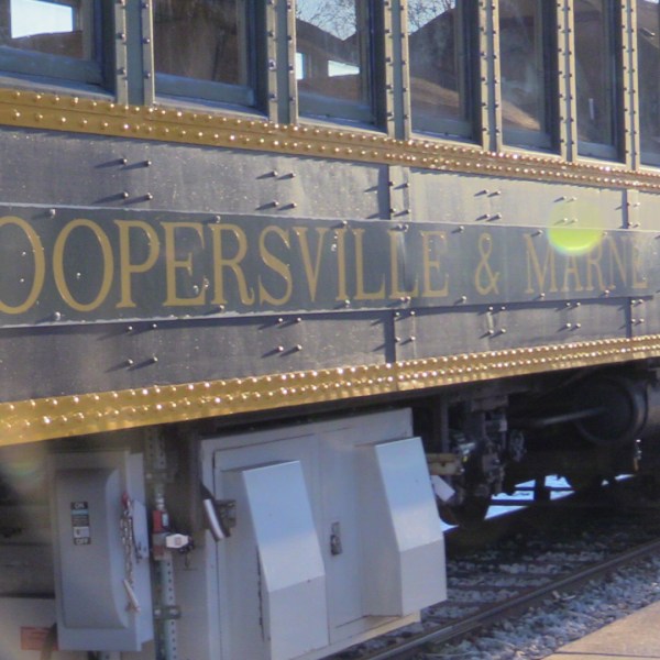 a train is parked on the side of a building