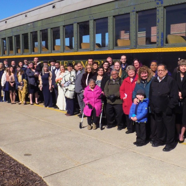a group of people standing in front of a crowd posing for the camera