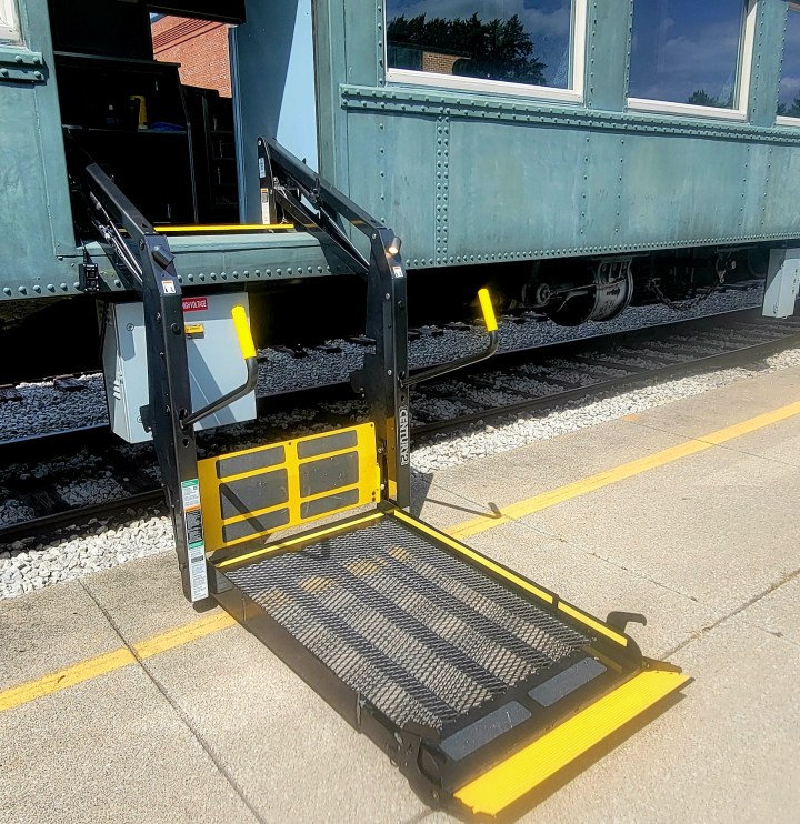 a train is parked on the side of a building