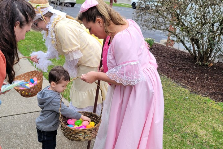 a couple of people that are standing in the grass