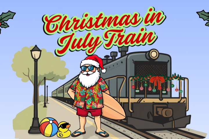 Santa in summer attire by a decorated train with 'Christmas in July Train' text.